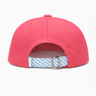 Pink cap with a blue and white striped strap on a white background