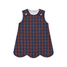 Henry Duvall Janie Jumper girls’ holiday dress in Tinsel Tartan, a navy, red and green plaid with subtle gold metallic thread, scalloped hem, navy piping and gold shoulder buttons.