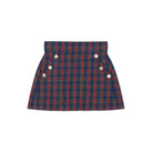 Girls’ Sadie Skirt in navy, red, and green Tinsel Tartan with subtle metallic thread, HD gold buttons, flat front, and A-line silhouette.