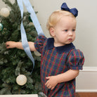Girls’ Beatrice Bubble in navy, red, and green Tinsel Tartan with subtle metallic thread, Midnight Blue Corduroy scalloped collar, and scalloped sleeve trim.