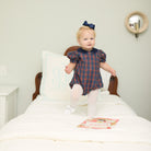 Girls’ Beatrice Bubble in navy, red, and green Tinsel Tartan with subtle metallic thread, Midnight Blue Corduroy scalloped collar, and scalloped sleeve trim.