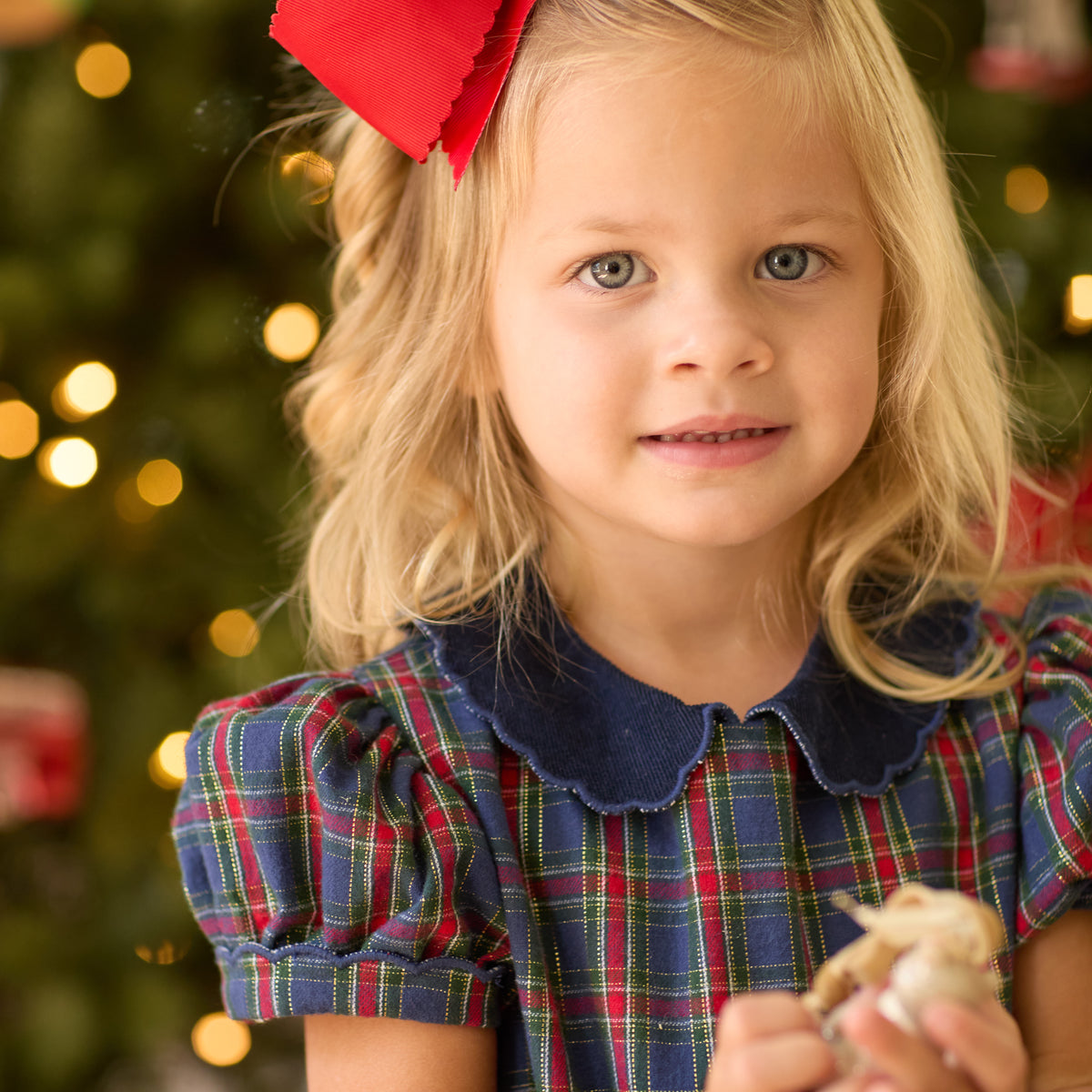 Girls’ Beatrice Bubble in navy, red, and green Tinsel Tartan with subtle metallic thread, Midnight Blue Corduroy scalloped collar, and scalloped sleeve trim.