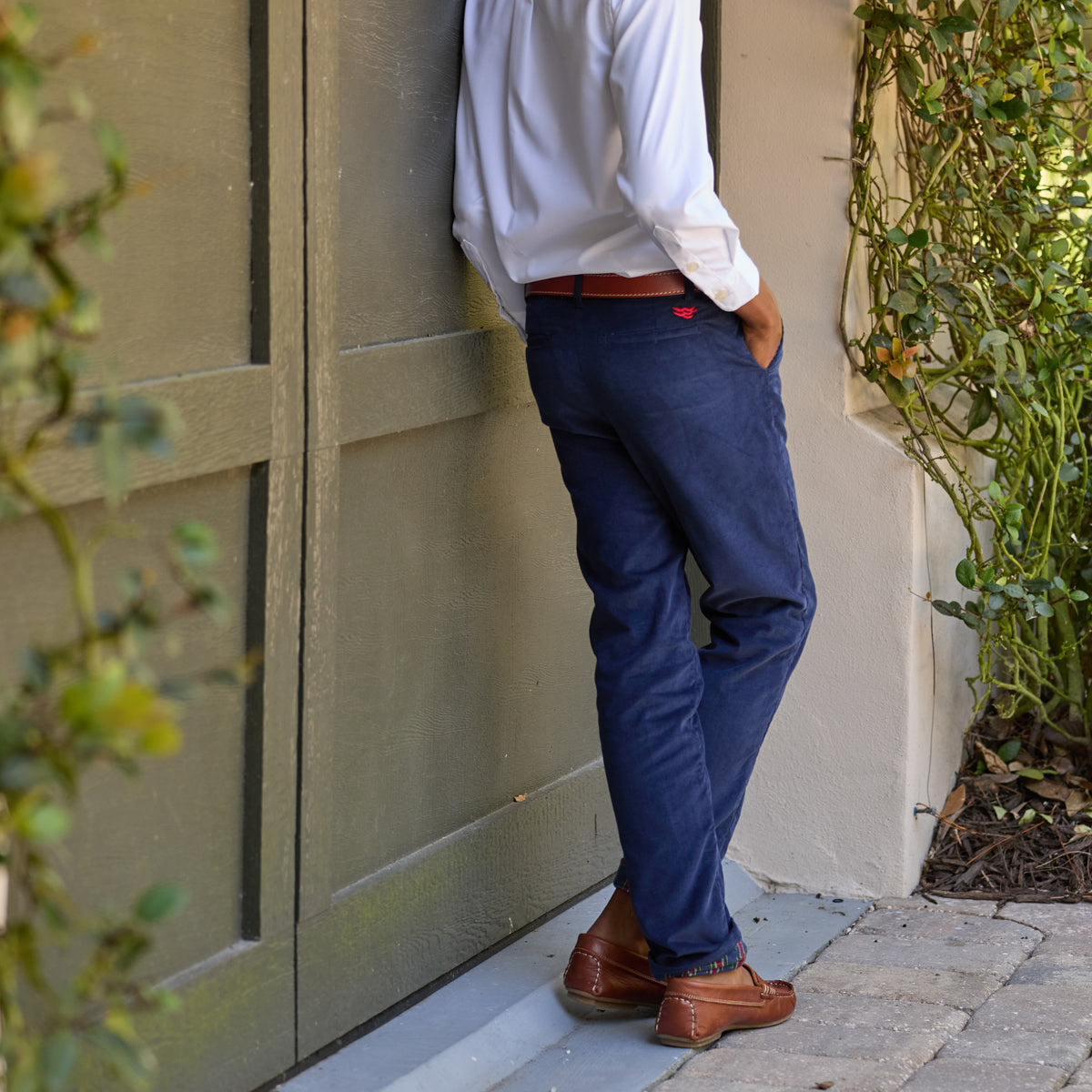 Boys’ Bradford Trousers in Midnight Blue Corduroy, fully lined in Tinsel Tartan with cuffed hems revealing festive navy, red, and green plaid.