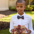 Boys’ pre-tied Baker Bow Tie in navy, red, and green Tinsel Tartan with subtle metallic thread and easy-on clasp.