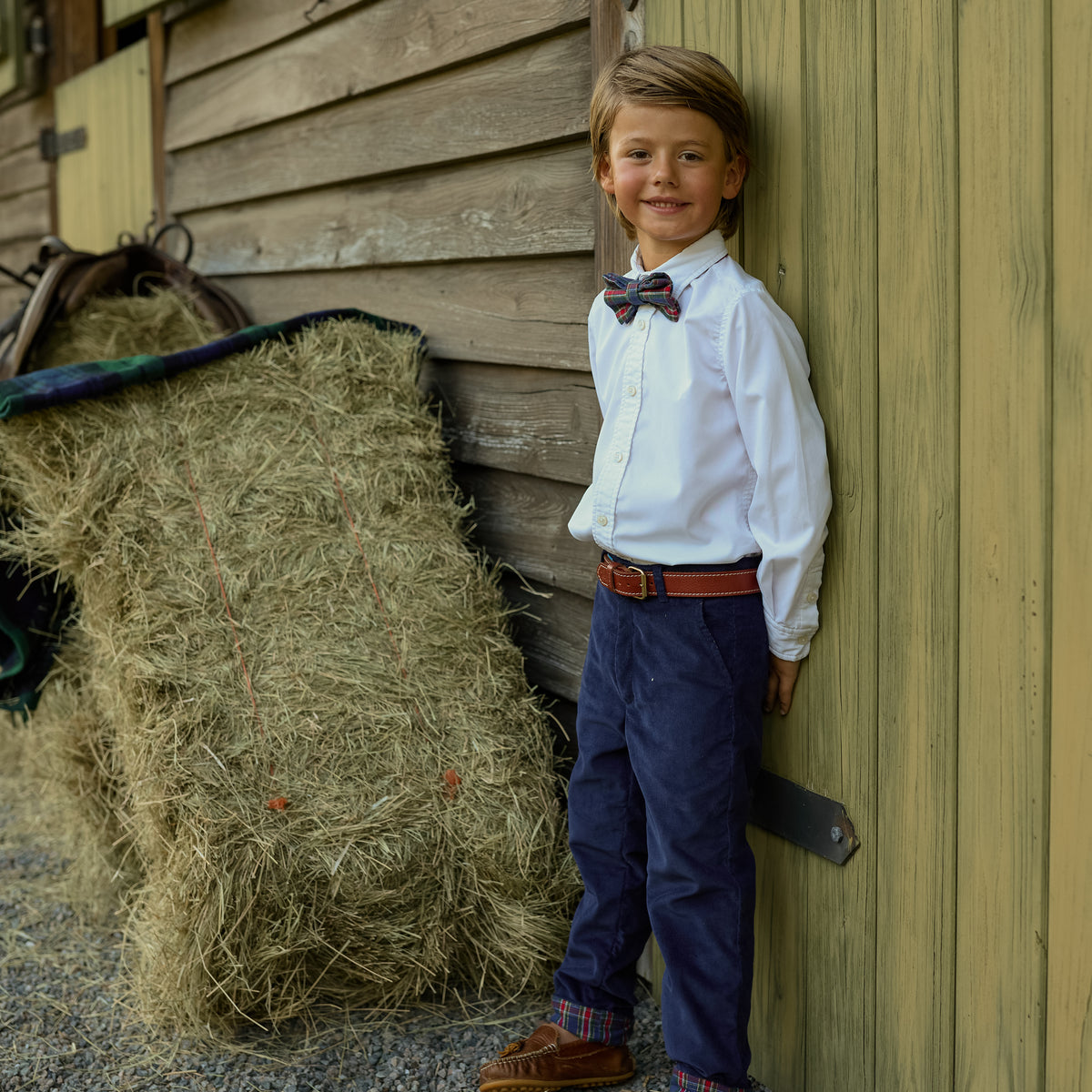 Boys’ pre-tied Baker Bow Tie in navy, red, and green Tinsel Tartan with subtle metallic thread and easy-on clasp.