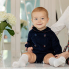 Baby boys’ Banks Bubble in Midnight Blue Corduroy with Tinsel Tartan-covered buttons and coordinating plaid trim at the Peter Pan collar and cuffs.