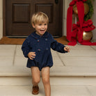 Baby boys’ Banks Bubble in Midnight Blue Corduroy with Tinsel Tartan-covered buttons and coordinating plaid trim at the Peter Pan collar and cuffs.