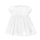 Henry Duvall Eloise Dress in white cotton with Bailey’s Bay Blue trim and hand-smocked sailboats, classic heirloom baby girl summer outfit with scalloped Peter Pan collar