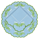 Decorative blue cloth with green leaf patterns on a white background