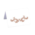 Folded tent-style Thanksgiving place cards with brown woodland leaf motif, matching fall tablecloths and Thanksgiving tabletop decor