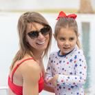 Henry Duvall Reese girls rashguard one piece in red white and blue star print, UPF 50+ long sleeve swimsuit for 4th of July, beach, and summer holidays