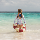 Henry Duvall Reese girls rashguard one piece in red white and blue star print, UPF 50+ long sleeve swimsuit for 4th of July, beach, and summer holidays