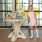 Girl wearing the Henry Duvall Rosie Dress, a classic pink girls dress designed for spring celebrations and family portraits.