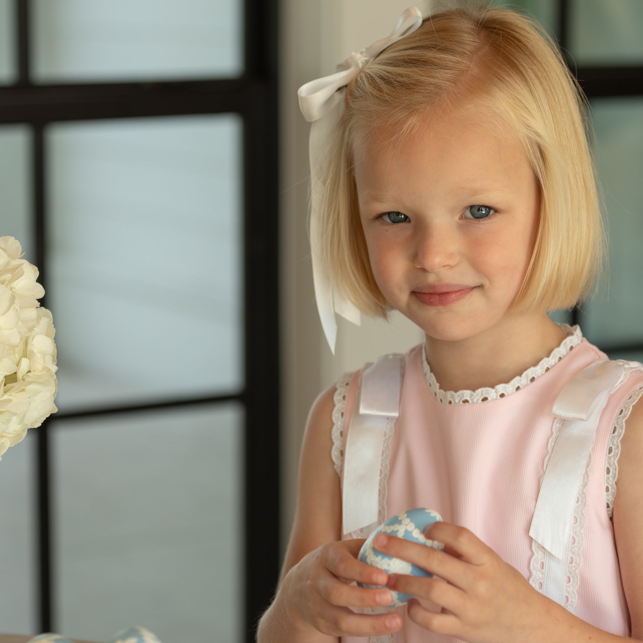 Girl wearing the Henry Duvall Rosie Dress, a classic pink girls dress designed for spring celebrations and family portraits.
