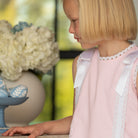 Girl wearing the Henry Duvall Rosie Dress, a classic pink girls dress designed for spring celebrations and family portraits.