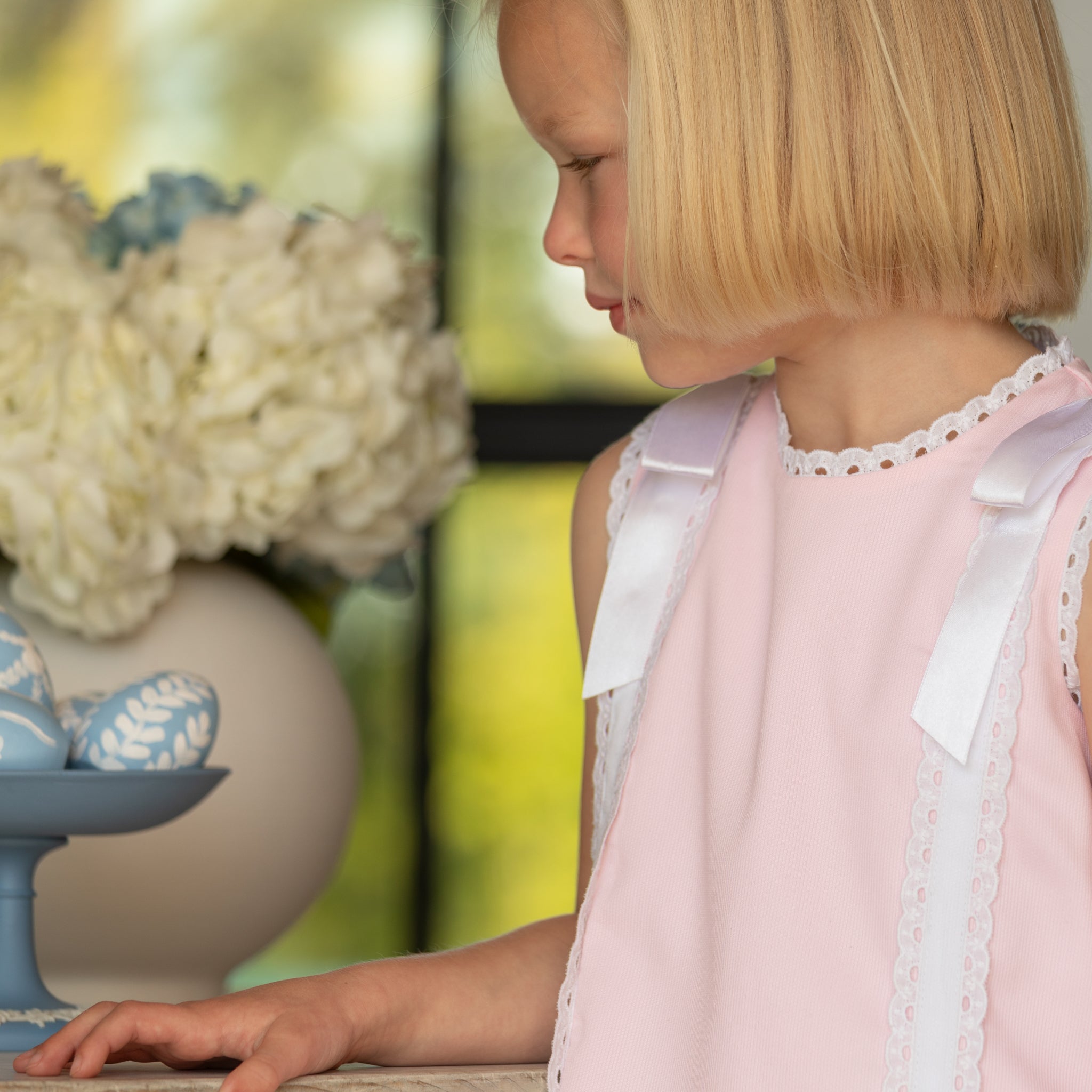 Girl wearing the Henry Duvall Rosie Dress, a classic pink girls dress designed for spring celebrations and family portraits.