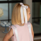 Girl wearing the Henry Duvall Rosie Dress, a classic pink girls dress designed for spring celebrations and family portraits.