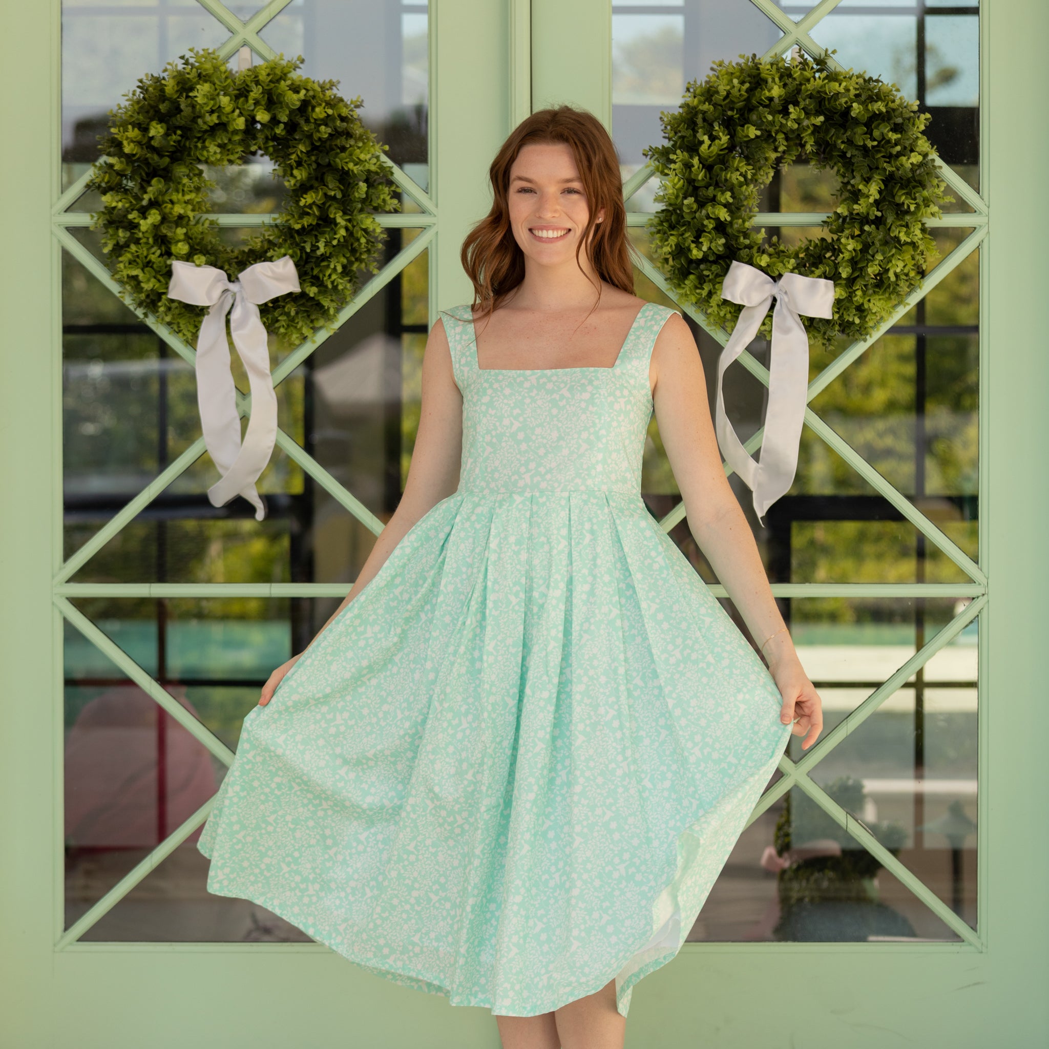 Woman styled in the Henry Duvall Ava Dress, a timeless floral midi dress designed for spring celebrations and family portraits.