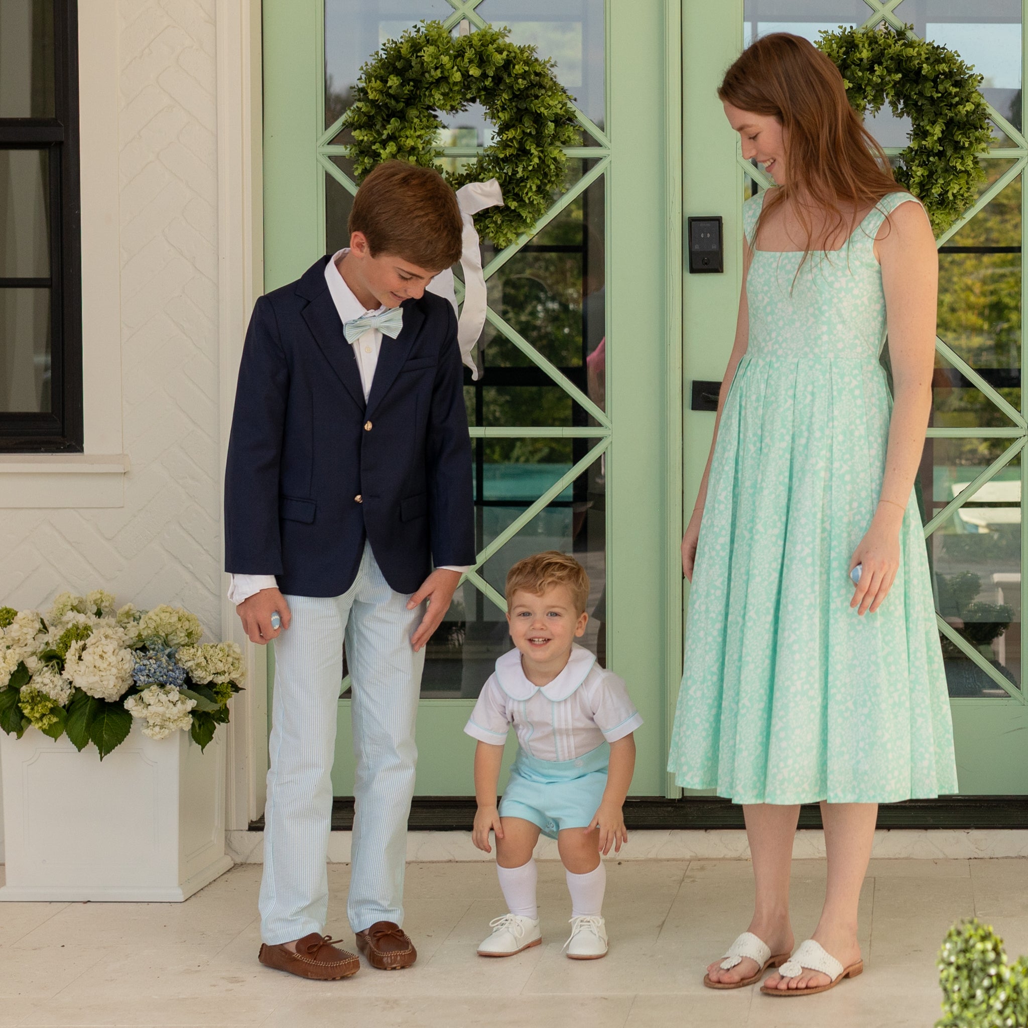 Woman styled in the Henry Duvall Ava Dress, a timeless floral midi dress designed for spring celebrations and family portraits.