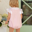 Toddler girl wearing the Henry Duvall Rosie Bubble, a classic pink bubble designed for spring days and special moments.