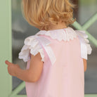 Toddler girl wearing the Henry Duvall Rosie Bubble, a classic pink bubble designed for spring days and special moments.