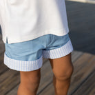 Boy wearing Henry Duvall Wyatt Shorts in East Beach Blue with striped cuffs, a classic boys short styled for spring days and timeless family moments