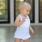 Baby boy wearing the Henry Duvall Henry Sunsuit in Seaside Stripe, a classic summer outfit designed for warm weather and sibling matching.