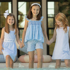 Girl wearing the Henry Duvall smocked shorts set in South Charles Stripe, a classic girls outfit designed for warm weather and family photos.