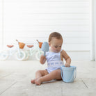 Baby girl wearing the Henry Duvall Sutton Sunsuit in Seaside Stripe, a classic summer outfit designed for warm weather and sibling matching.