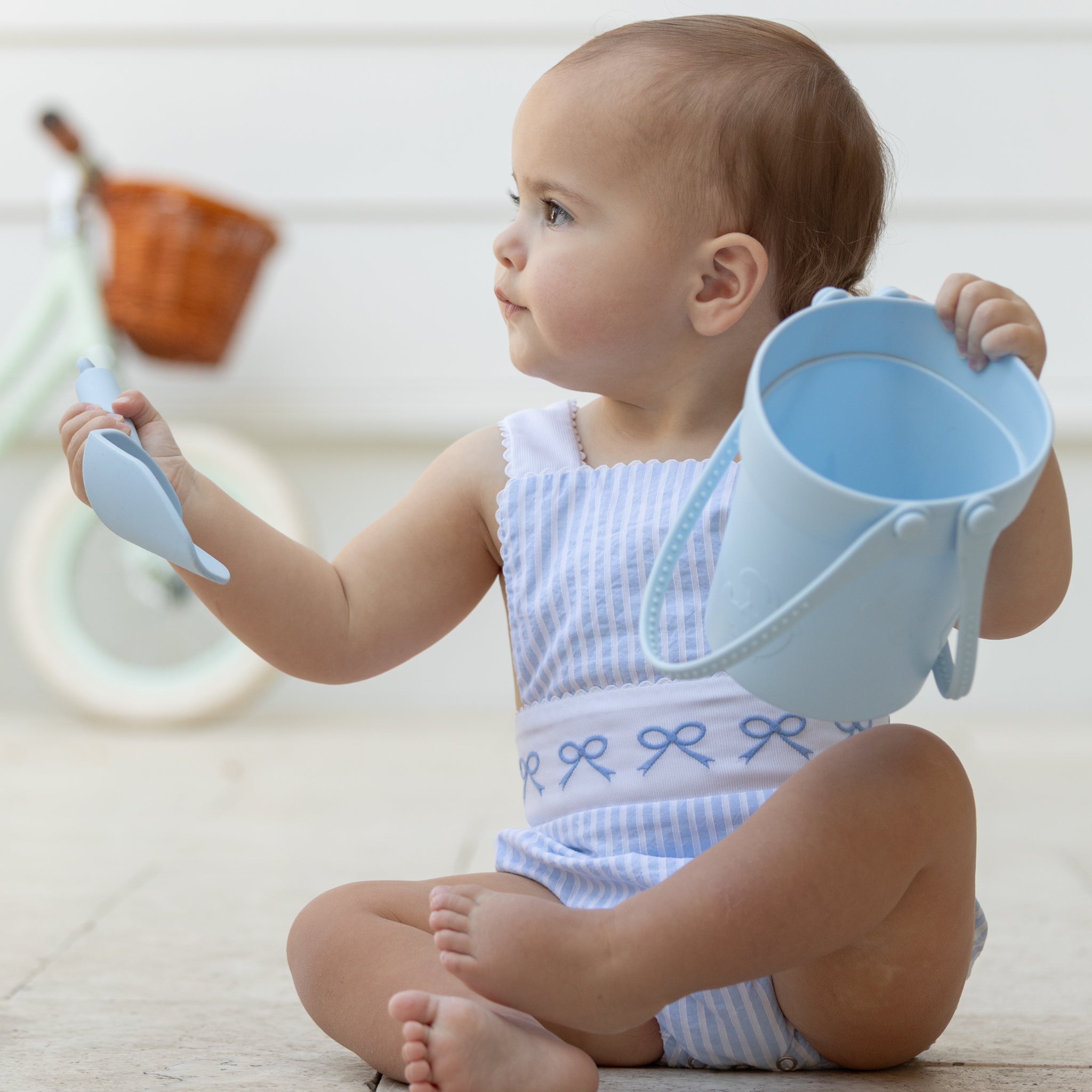 Baby girl wearing the Henry Duvall Sutton Sunsuit in Seaside Stripe, a classic summer outfit designed for warm weather and sibling matching.