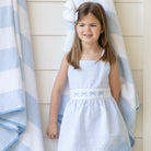 Girl wearing the Henry Duvall Campbell Dress in Seaside Stripe, a classic girls dress designed for warm weather and sibling matching