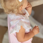 Toddler girl wearing the Henry Duvall Rosie Bubble, a classic pink bubble designed for spring days and special moments.