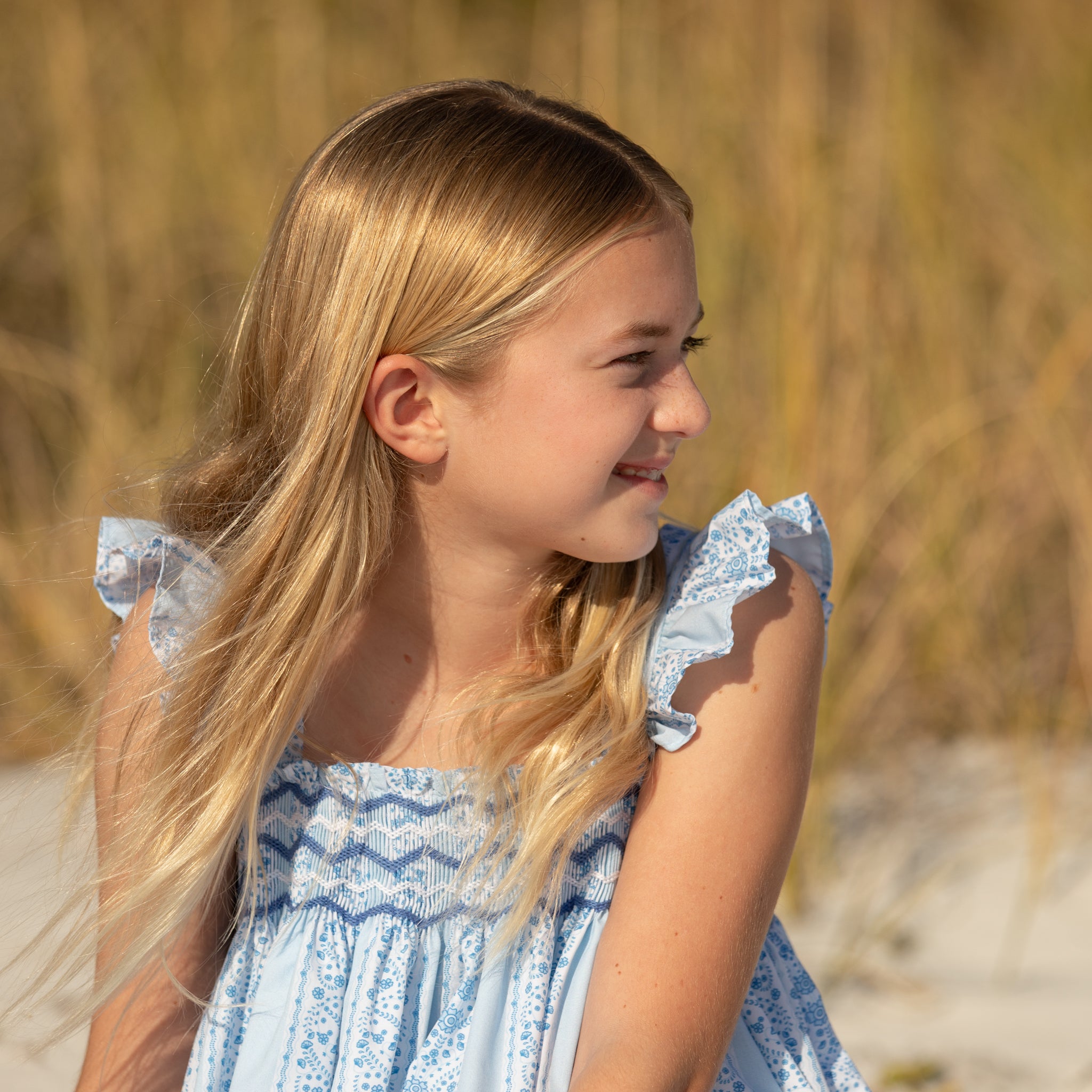 Girl wearing the Henry Duvall smocked shorts set in South Charles Stripe, a classic girls outfit designed for warm weather and family photos.