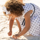 Henry Duvall Betsy Dress in white cotton with navy polka dots and grosgrain bow, classic twirl dress for girls that transitions from summer to fall