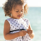 Henry Duvall Betsy Dress in white cotton with navy polka dots and grosgrain bow, classic twirl dress for girls that transitions from summer to fall