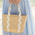 Henry Duvall curated Ridgely Tote by Breck & Grier, a classic straw tote bag with woven body and vegan leather handles.
