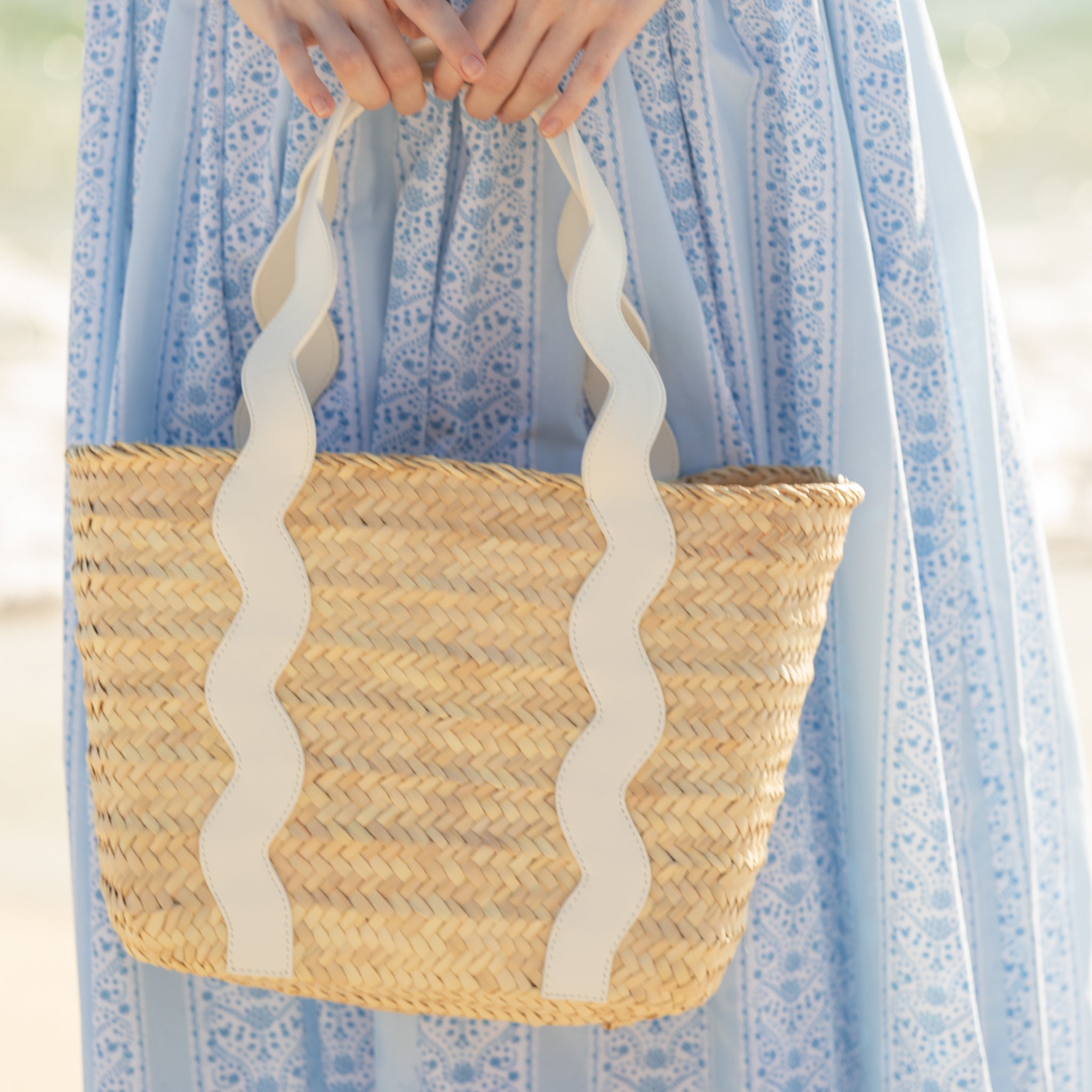Henry Duvall curated Ridgely Tote by Breck & Grier, a classic straw tote bag with woven body and vegan leather handles.