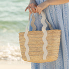 Henry Duvall curated Ridgely Tote by Breck & Grier, a classic straw tote bag with woven body and vegan leather handles.