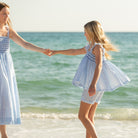 Girl wearing the Henry Duvall smocked shorts set in South Charles Stripe, a classic girls outfit designed for warm weather and family photos.