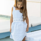 Girl wearing the Henry Duvall Campbell Dress in Seaside Stripe, a classic girls dress designed for warm weather and sibling matching