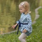 Henry Duvall Hazel Bubble in Prescott Petals floral with Back Bay Blue Velvet bow, classic baby girl fall romper designed to coordinate with sibling and mommy styles