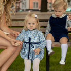 Henry Duvall Hazel Bubble in Prescott Petals floral with Back Bay Blue Velvet bow, classic baby girl fall romper designed to coordinate with sibling and mommy styles