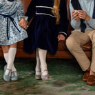 Girls long sleeve navy velvet party dress with white pleated details and pre-tied back bow, perfect for fall family photos and special occasions from Henry Duvall