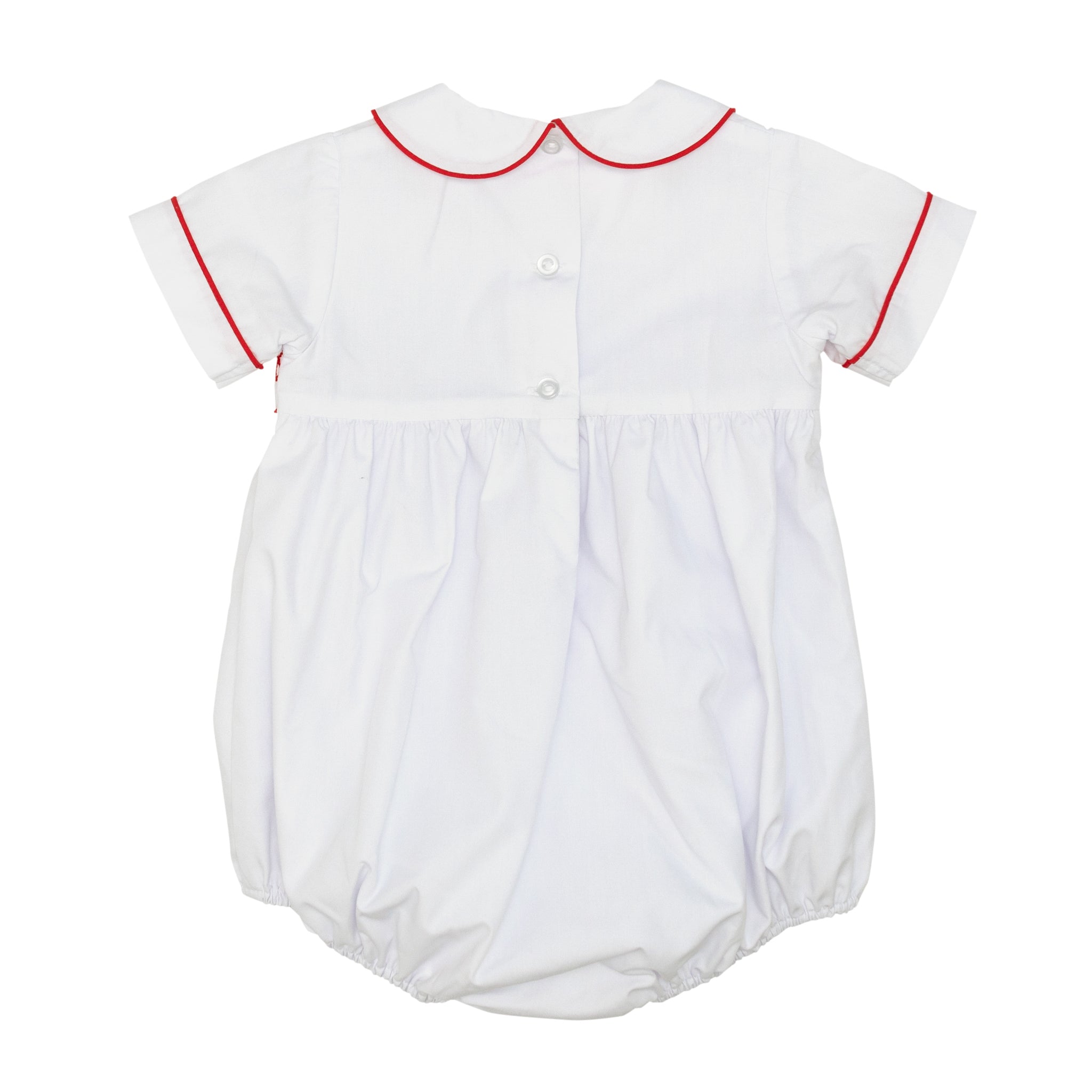 White baby boy holiday bubble with red toy soldier smocking and Peter Pan collar, Henry Duvall's Charlie Bubble in cotton poplin for Christmas celebrations