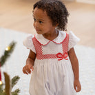 White short sleeve baby girl holiday bubble with red smocked bows, Peter Pan collar, and piped cuffs, classic Eloise Bubble by Henry Duvall for Christmas and winter celebrations