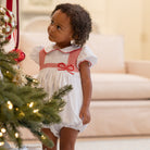 White short sleeve baby girl holiday bubble with red smocked bows, Peter Pan collar, and piped cuffs, classic Eloise Bubble by Henry Duvall for Christmas and winter celebrations