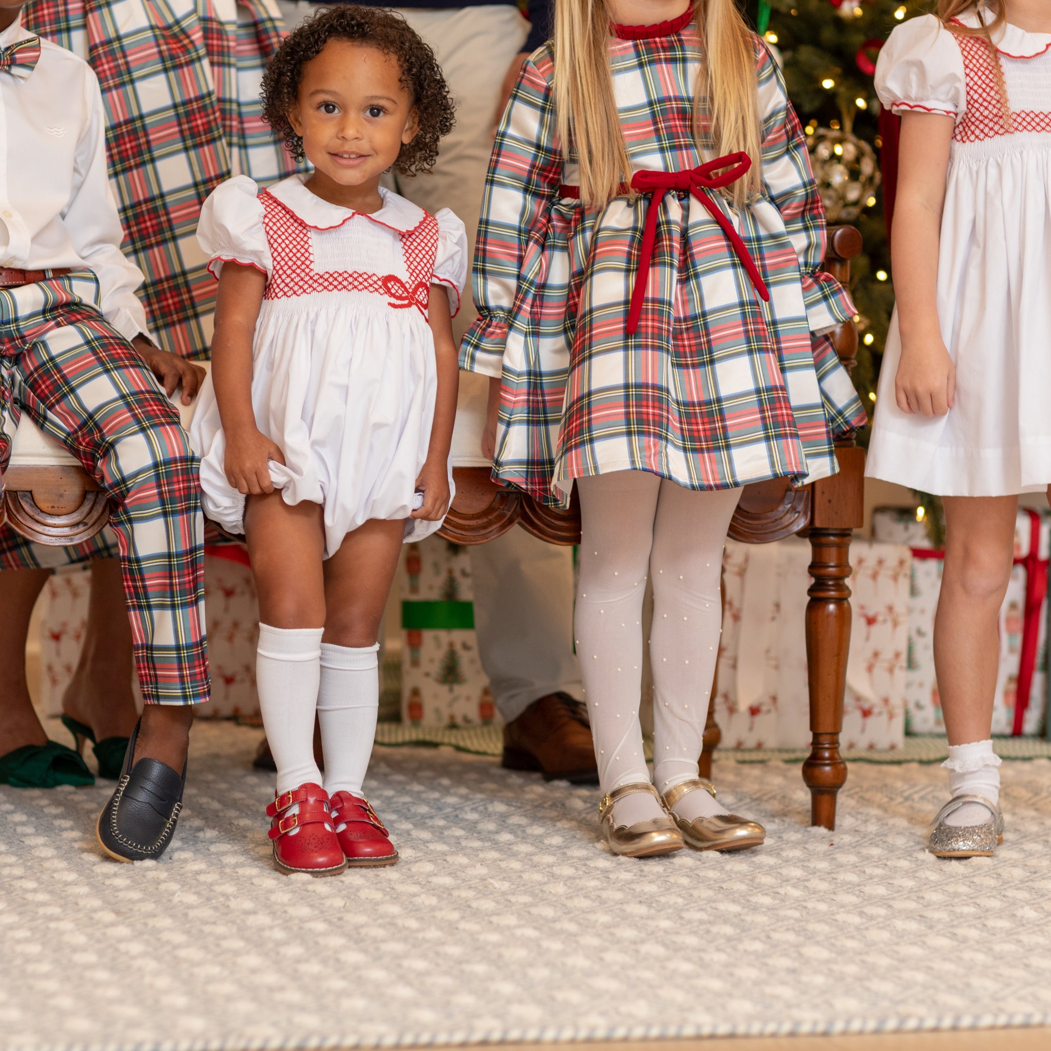 White short sleeve baby girl holiday bubble with red smocked bows, Peter Pan collar, and piped cuffs, classic Eloise Bubble by Henry Duvall for Christmas and winter celebrations