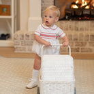 White baby boy holiday bubble with red toy soldier smocking and Peter Pan collar, Henry Duvall's Charlie Bubble in cotton poplin for Christmas celebrations
