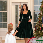 Classic women’s holiday dress in Grafton Green Velvet with tartan bow, elegant Christmas outfit to coordinate with children, Henry Duvall womenswear