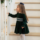 Henry Duvall Eliza Dress for girls in Grafton Green Velvet with white scalloped trim and a Newbury Tartan pre-tied sash, classic holiday dress for festive occasions